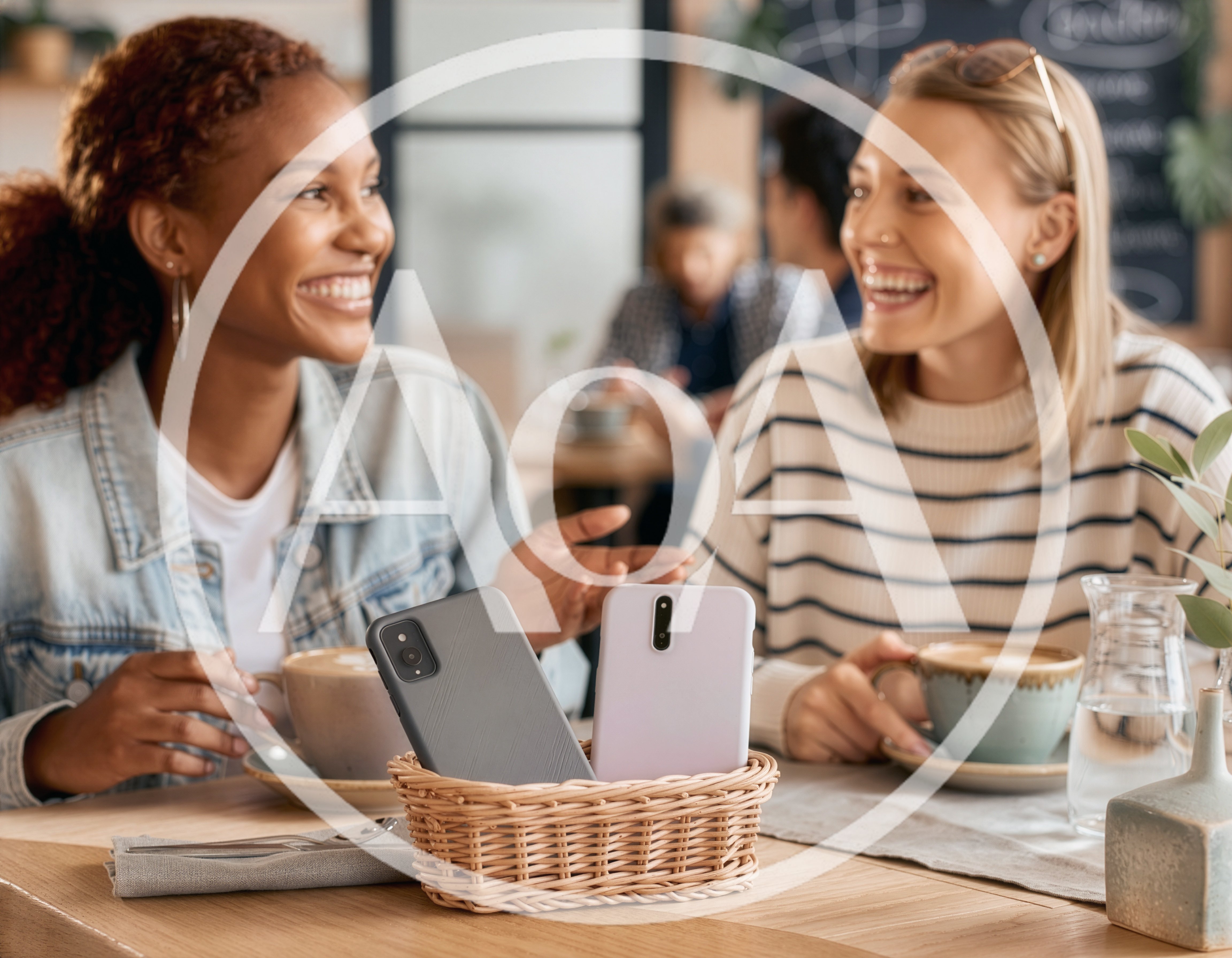 Two Happy Women Chatting Over Coffee in a Cafe