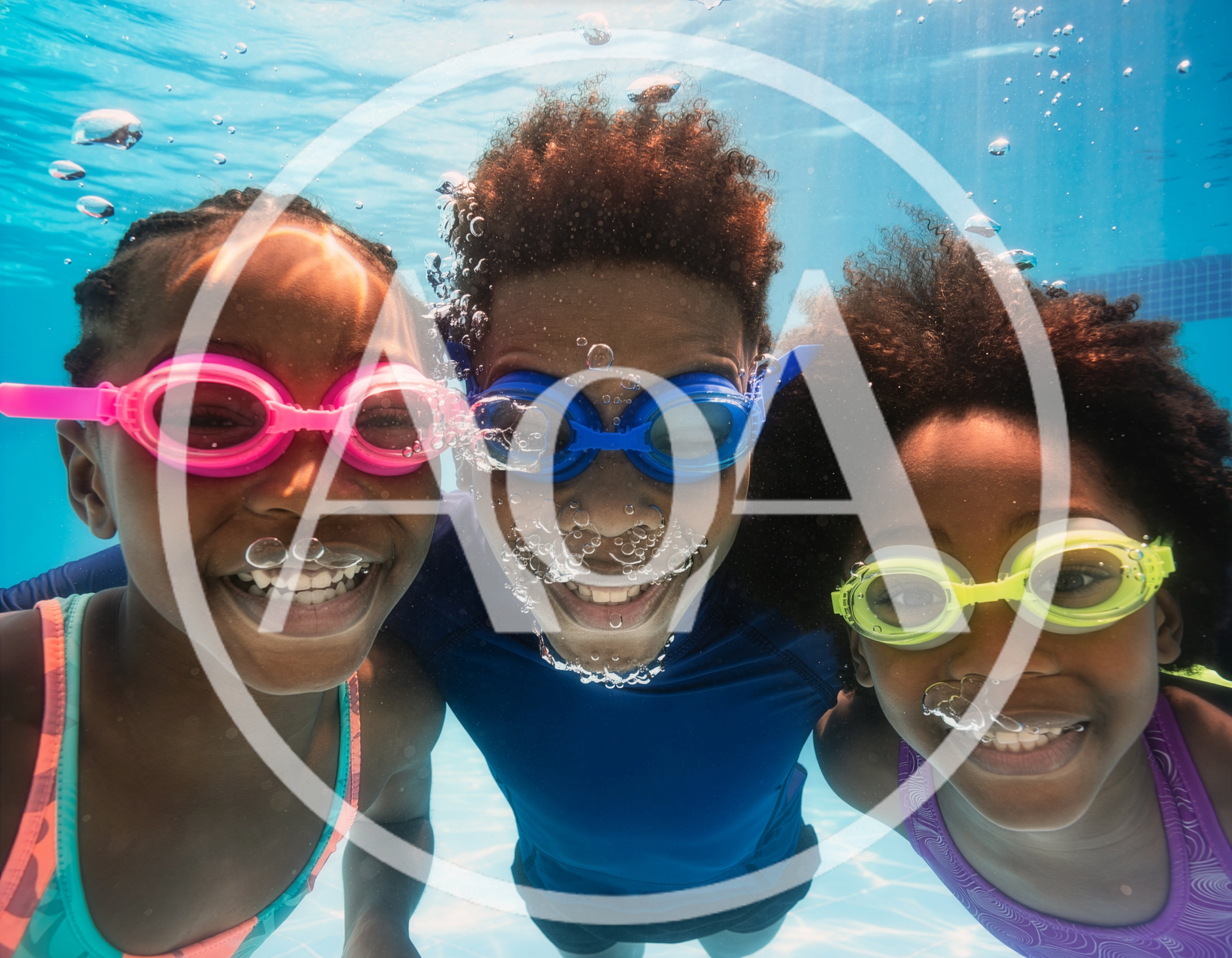 Three Children Swimming Underwater In A Pool