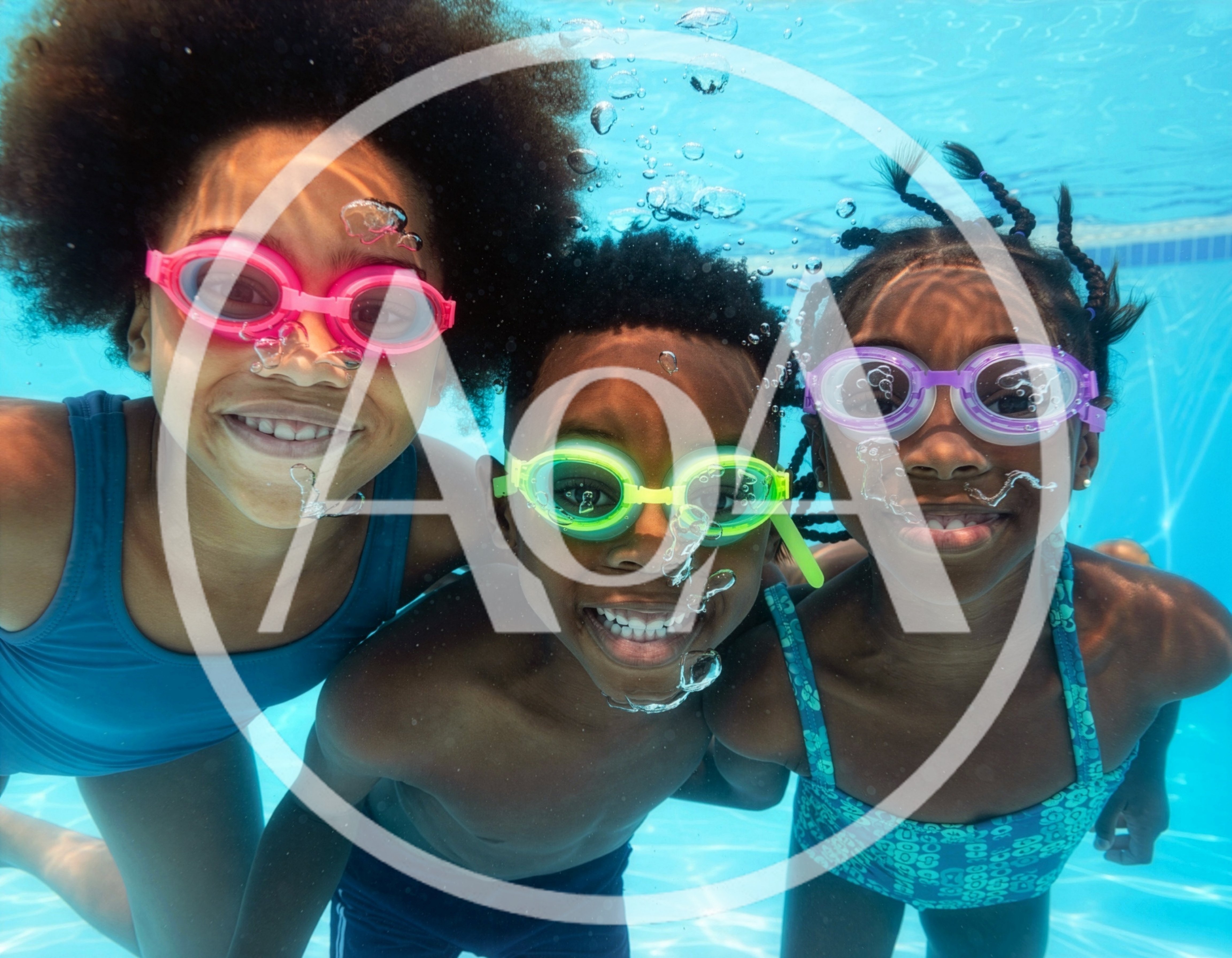 Three Children Swimming Underwater In A Pool