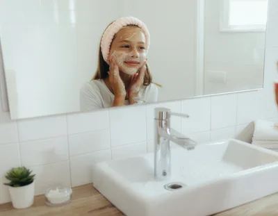 Young Girl Washing Face With Cleansing Foam