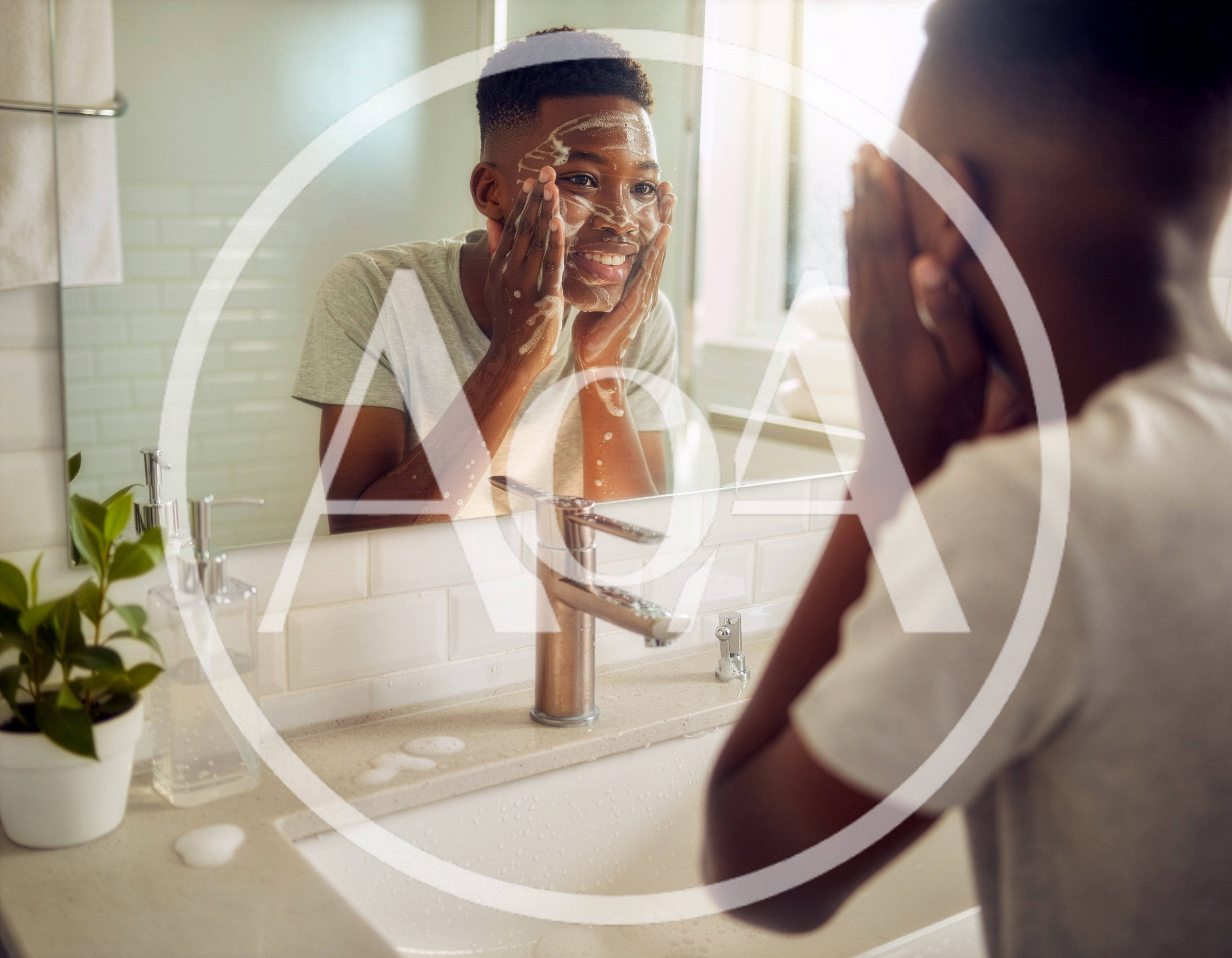 Young Man Washing Face With Soap In Bathroom