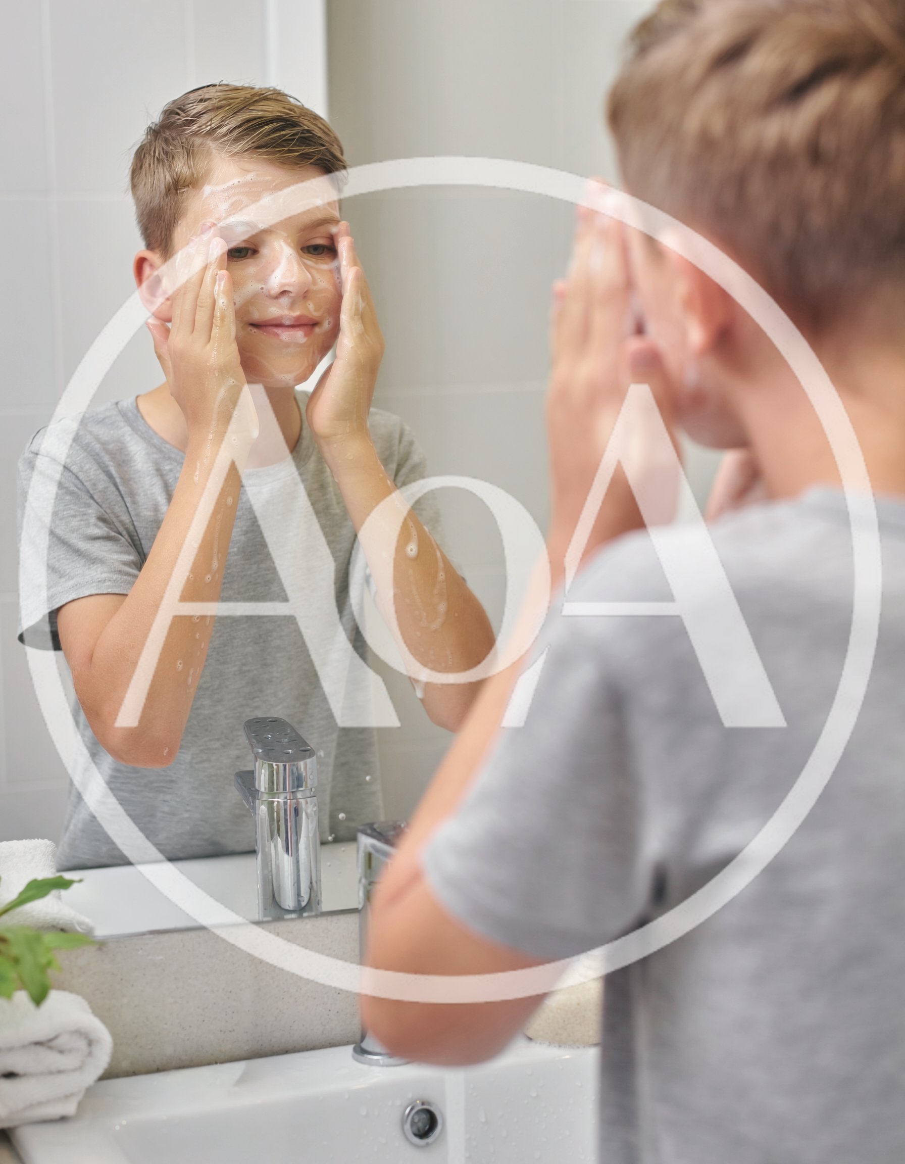 Young Boy Washing Face With Soap In Bathroom Mirror