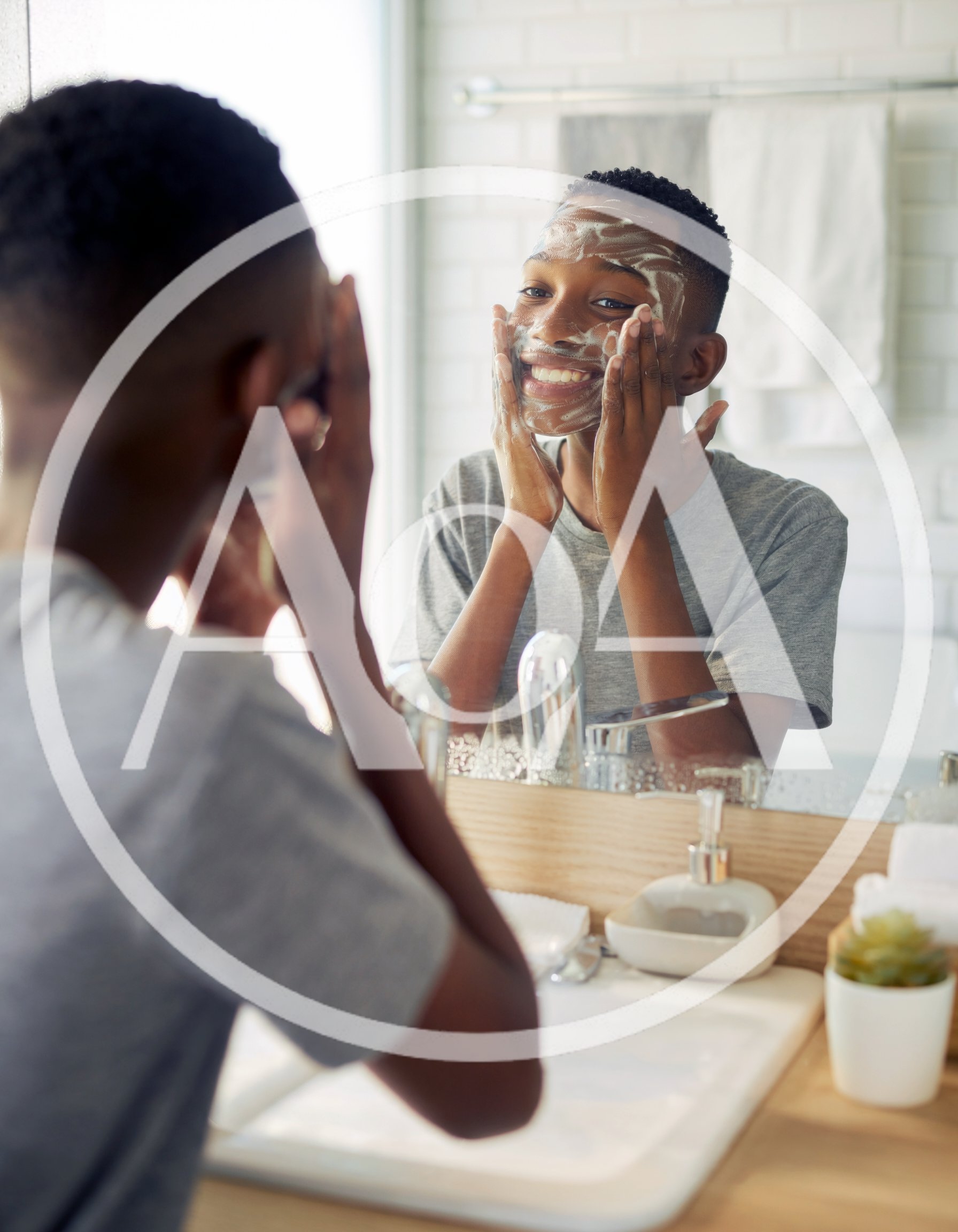 Young Black Man Washing Face With Cleanser In Bathroom