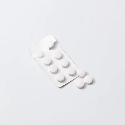 White Pills In A Blister Pack On White Background