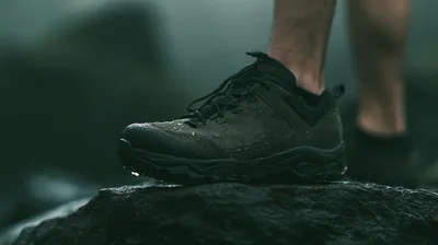 Close Up Of Hiking Shoe On Wet Rock