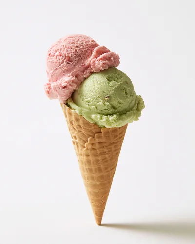 Double Scoop Ice Cream Cone With Strawberry And Pistachio