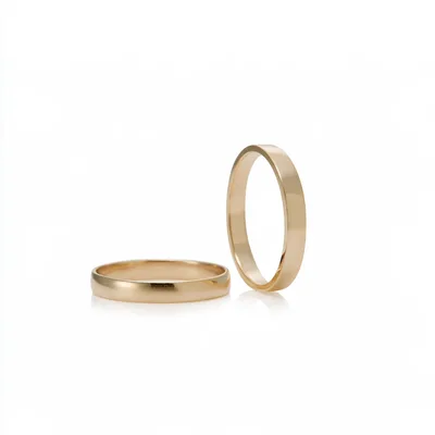 Two Gold Wedding Bands On White Background