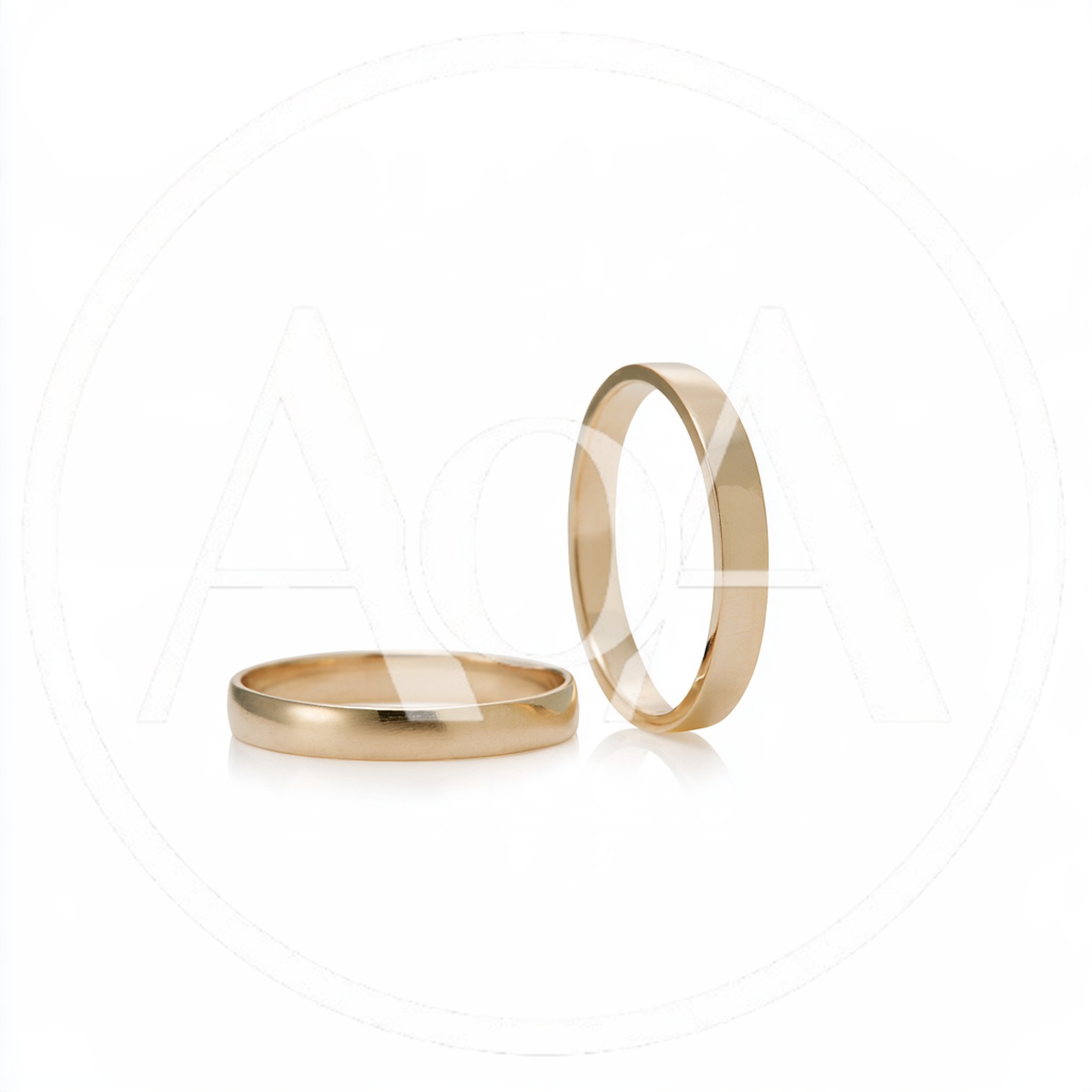 Two Gold Wedding Bands On White Background