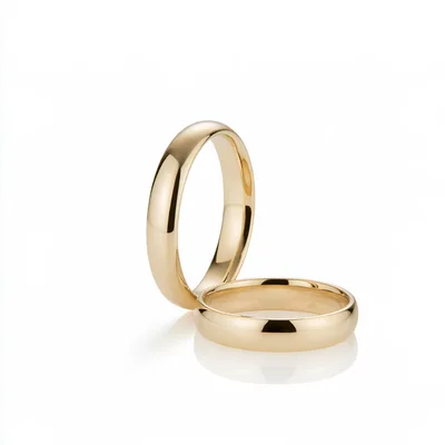 Two Polished Gold Wedding Bands On White Background