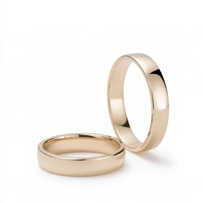 Two Classic Gold Wedding Bands On White Background
