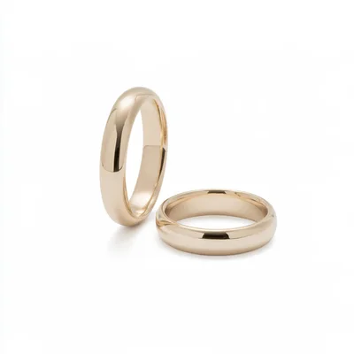 Two Classic Gold Wedding Bands On White Background