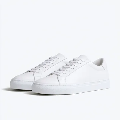 Pair Of Minimalist White Leather Sneakers