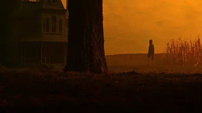 Spooky Haunted House With Scarecrow In Cornfield