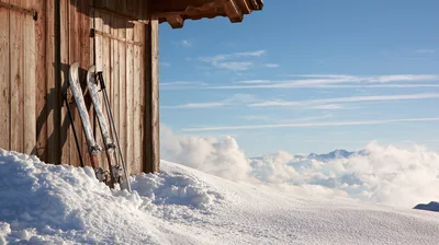 Skis Leaning Against A Wooden Alpine Hut