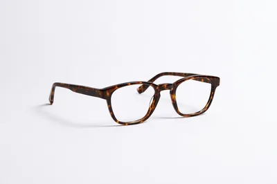 Tortoiseshell Eyeglasses Resting On A Plain White Background