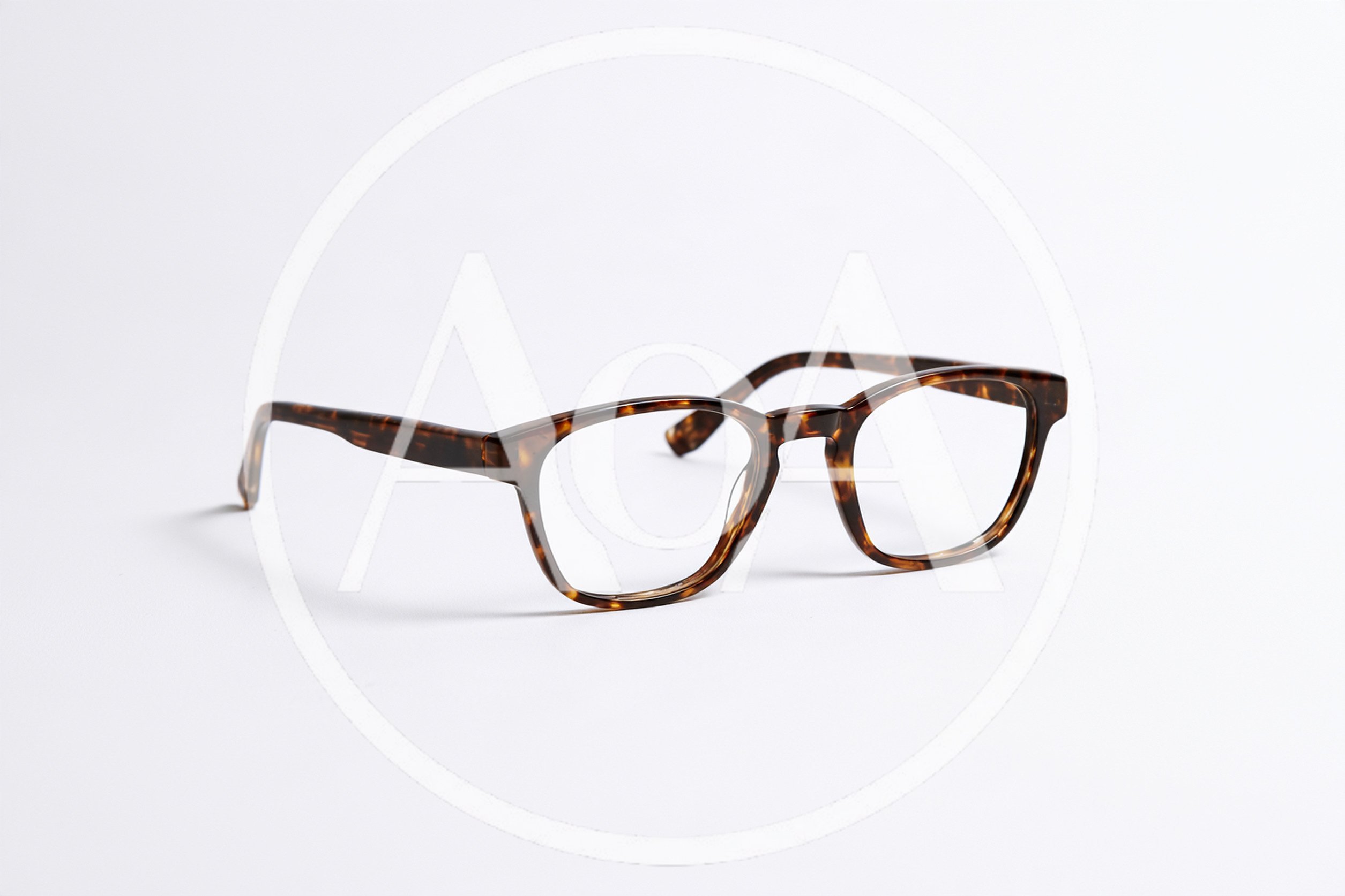 Tortoiseshell Eyeglasses Resting On A Plain White Background