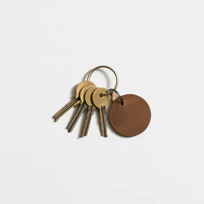 Brass Keys With Leather Tag On White Background
