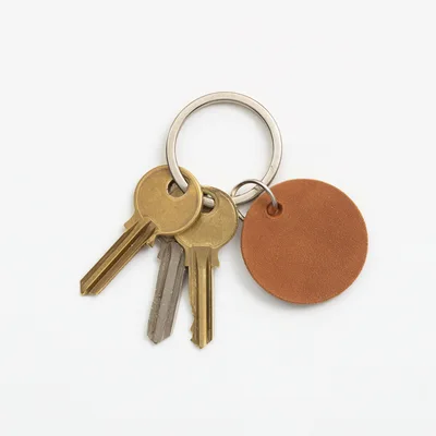 Three Metal Keys on a Round Leather Keychain