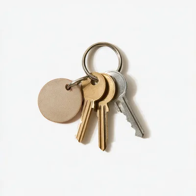 Set Of Metal Keys With A Blank Leather Keychain