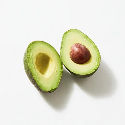 Two Halves Of A Fresh Ripe Avocado