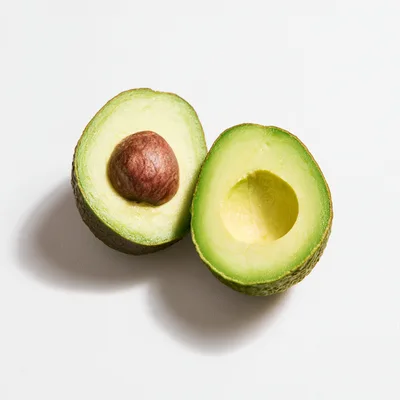 Two Halves Of A Fresh Ripe Avocado