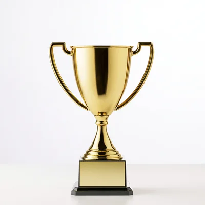 Shiny Gold Trophy Cup On A White Surface