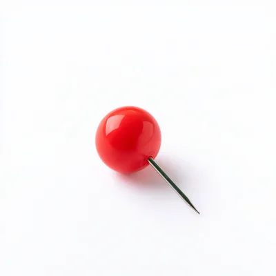 Single Red Push Pin On White Background