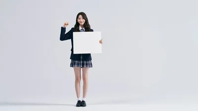Young Woman In School Uniform Holding Blank Sign