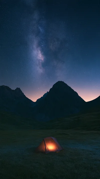 Illuminated Camping Tent Under Milky Way Galaxy