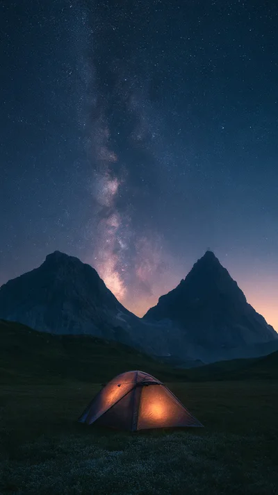 Illuminated Camping Tent Under Milky Way Galaxy