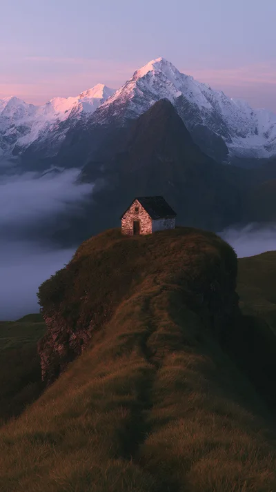 Small Stone Hut On A Grassy Mountain Ridge