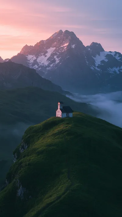 Small Stone Chapel On A Grassy Mountain Peak