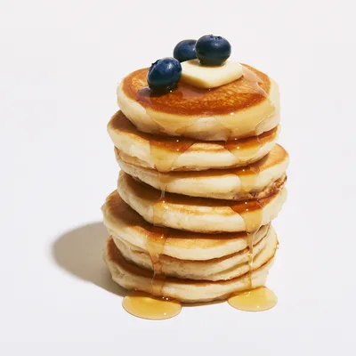 Stack of Fluffy Pancakes with Blueberries and Syrup