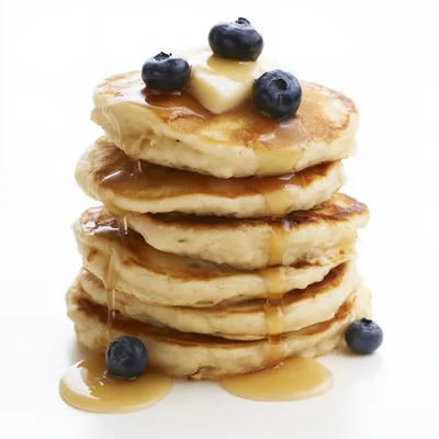 Stack Of Fluffy Pancakes With Blueberries And Syrup