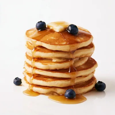 Stack Of Fluffy Pancakes With Blueberries And Syrup