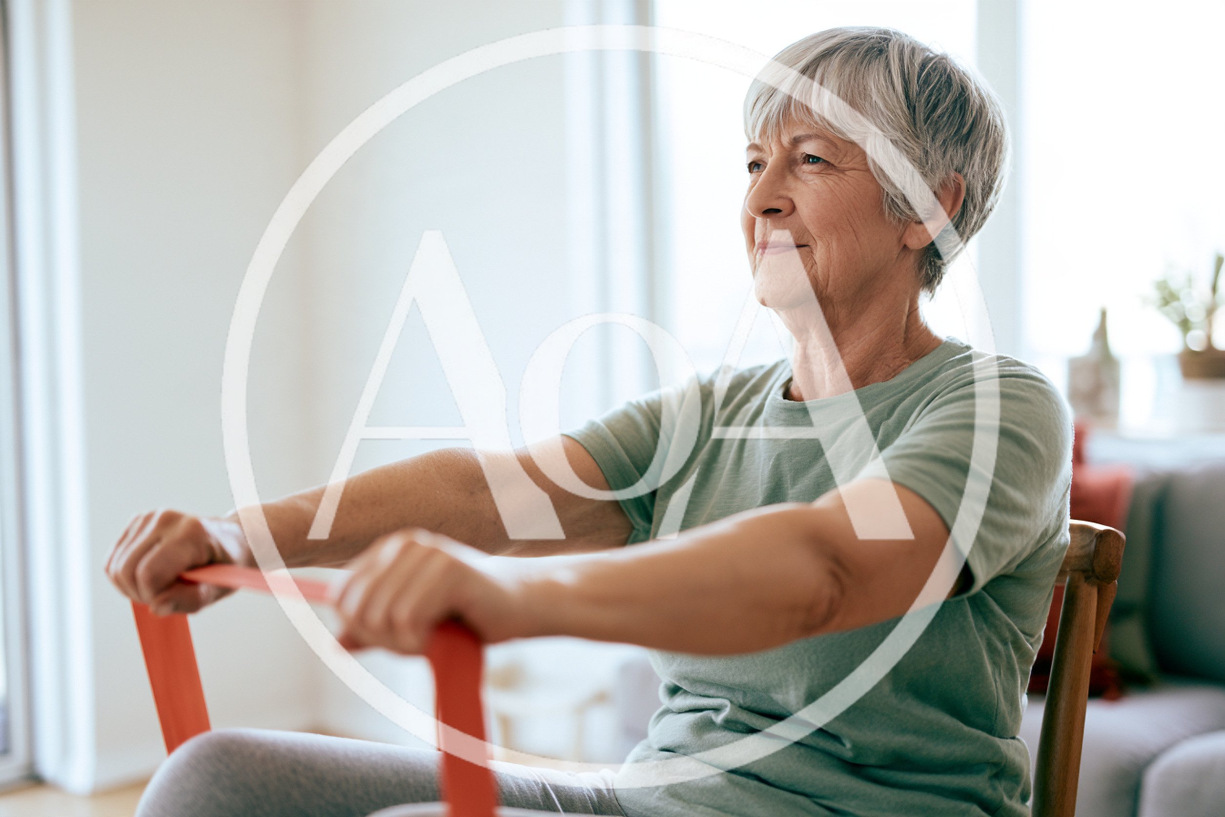 Senior Woman Exercising With Resistance Band At Home