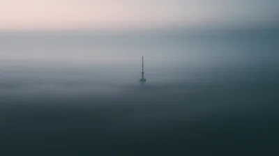 Communication Tower Rising Above A Thick Sea Of Fog