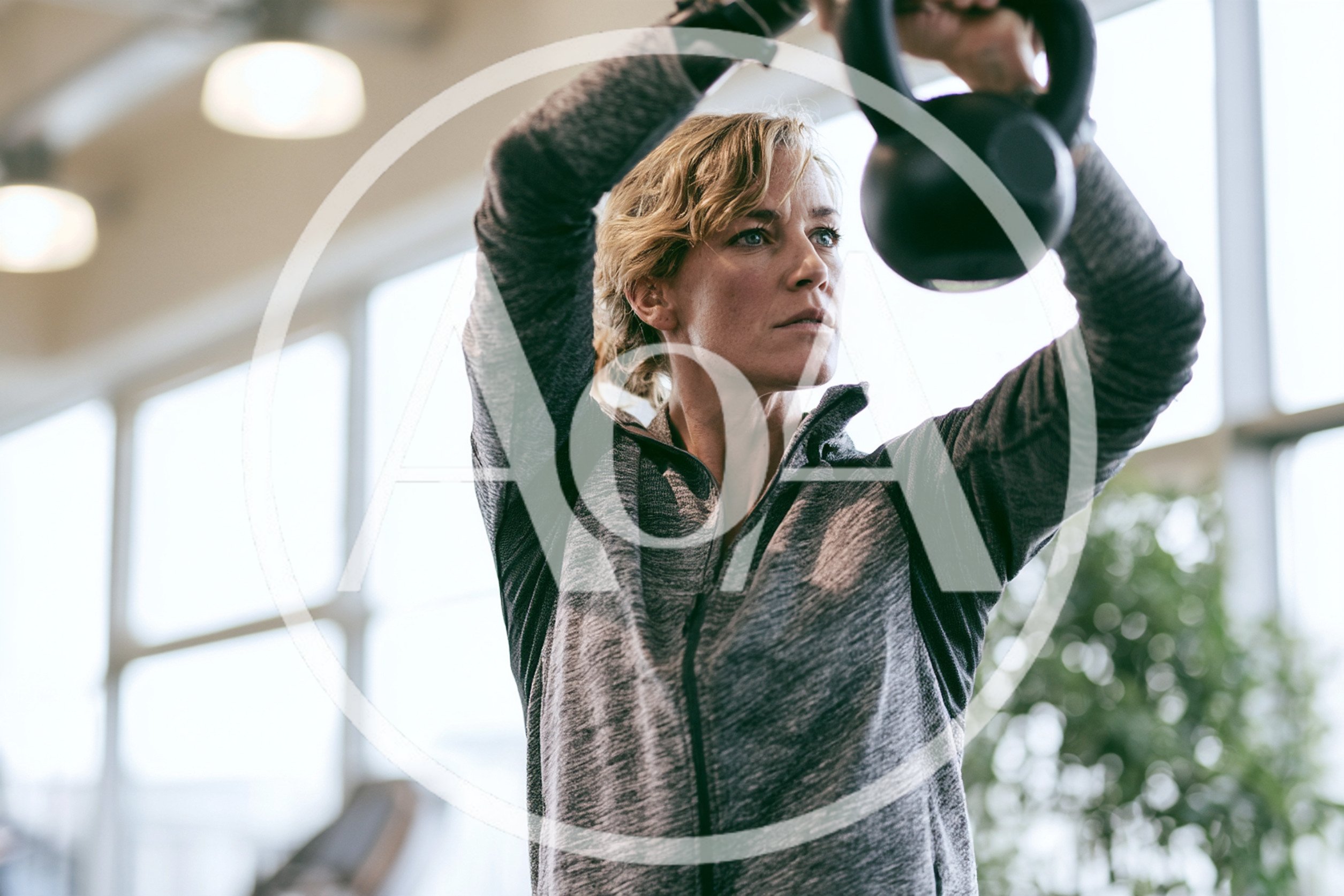 Woman Exercising With Kettlebell In A Gym