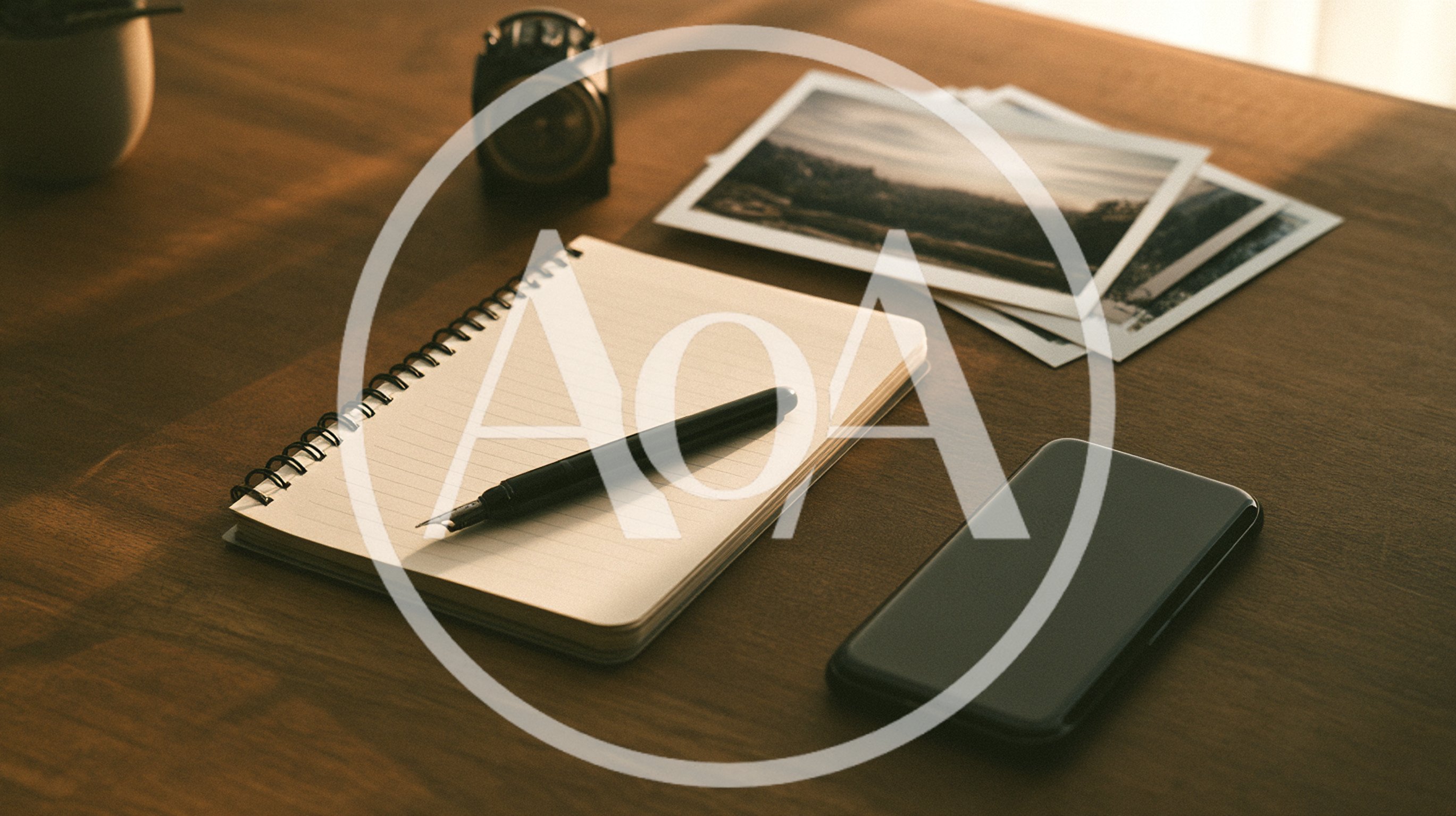 Notebook With Fountain Pen And Smartphone On Wooden Desk