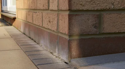 Close Up Of A Brick Wall Corner And Paving
