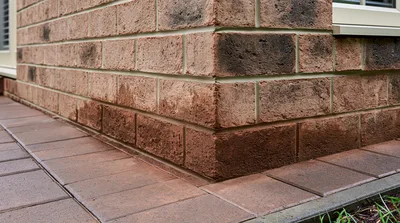Close Up Of Exterior Brick Wall Corner And Pavers