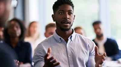 Young Black Man Speaking During A Business Meeting
