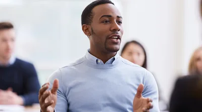 African American Man Speaking During Business Meeting