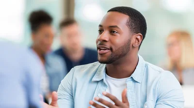Young African American Man Speaking During Office Meeting