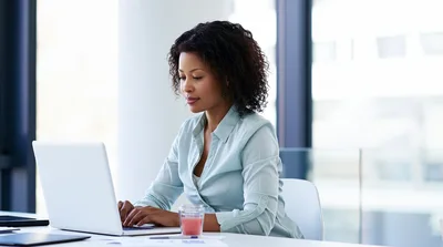 Professional Woman Working On Laptop In Modern Office