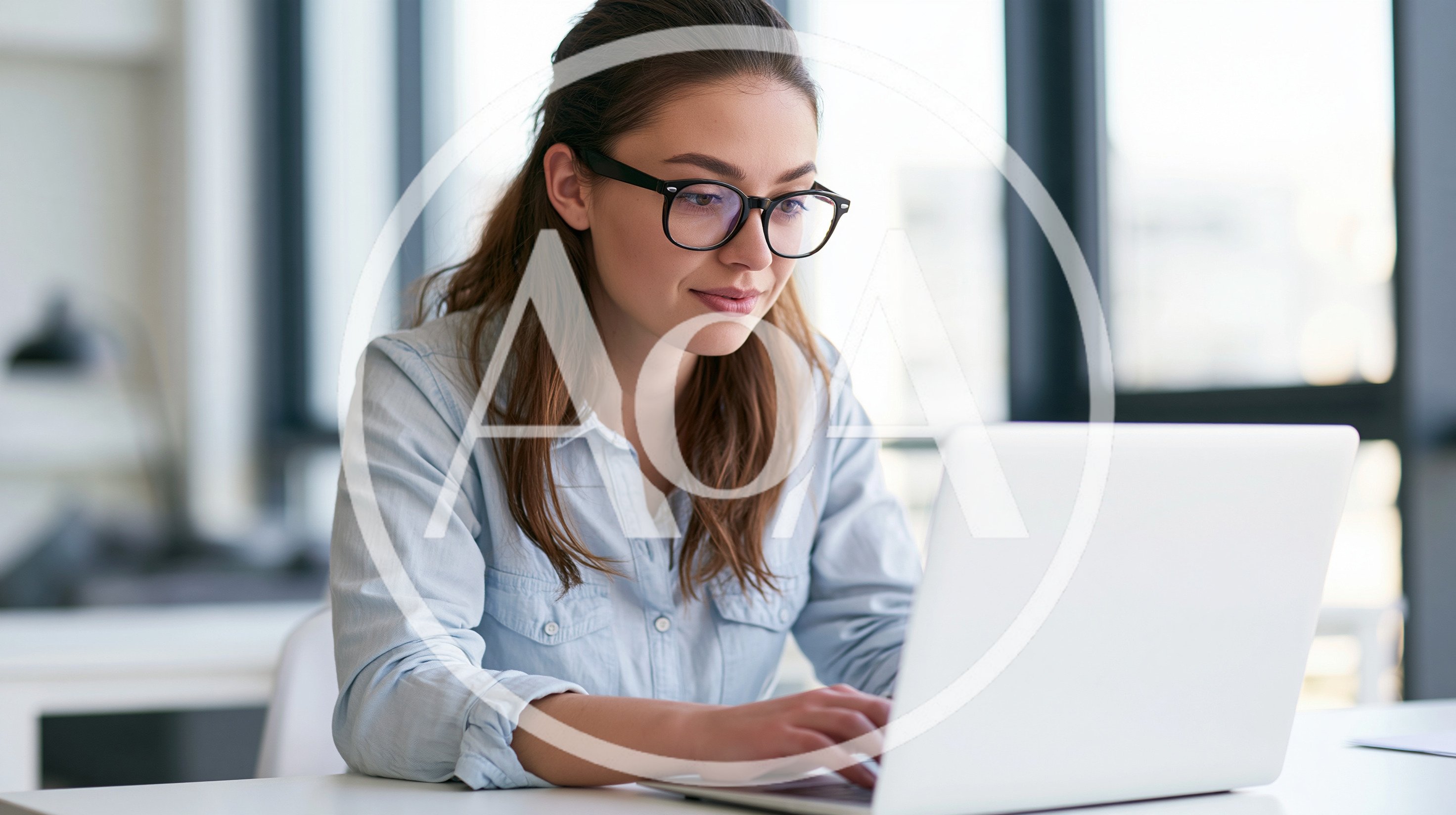Young Woman Working On Laptop In Modern Office