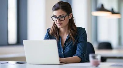 Professional Woman Working On Laptop In Modern Office