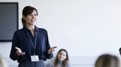 Professional Woman Giving A Presentation In A Meeting