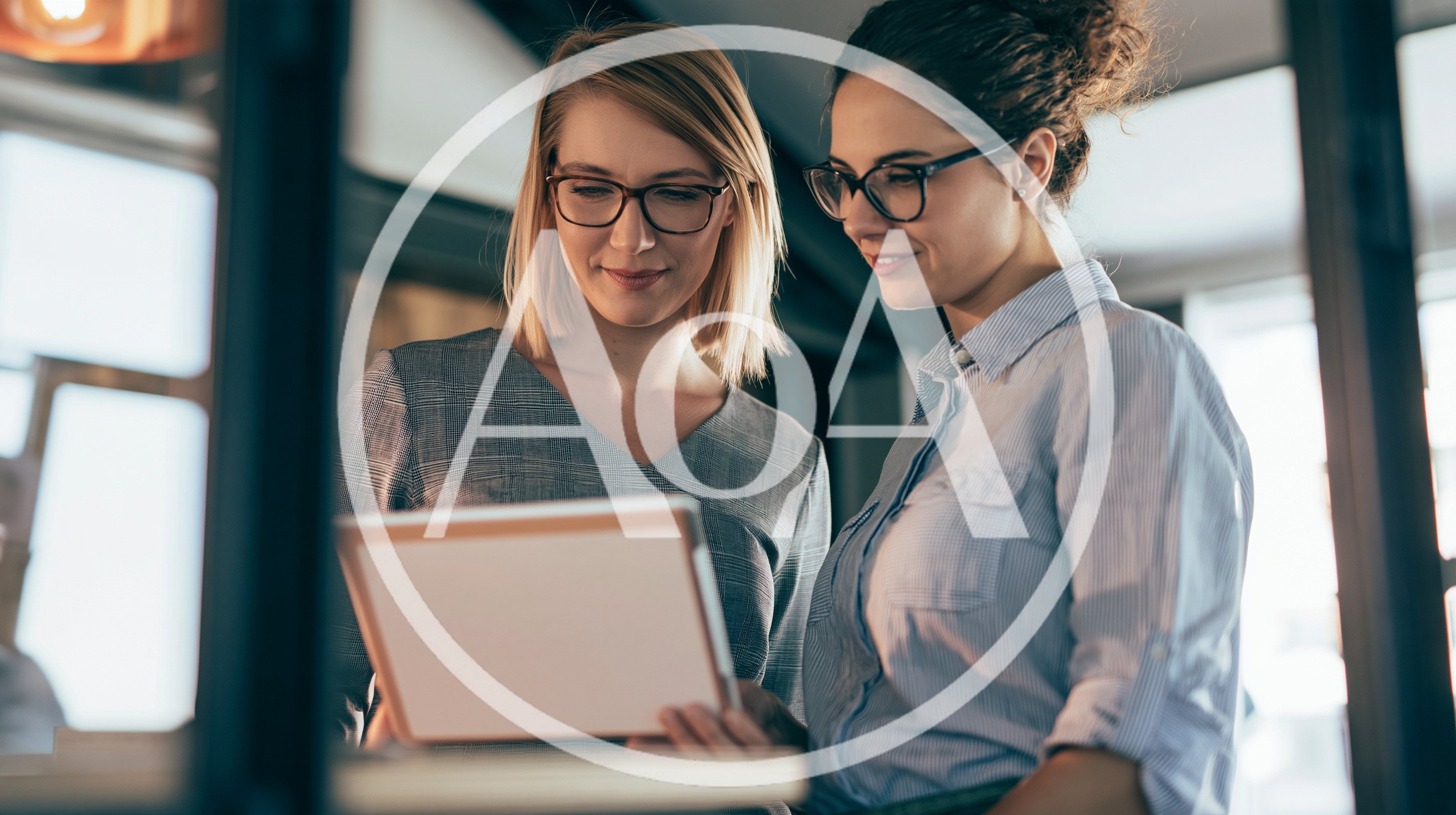 Two Professional Women Collaborating on a Digital Tablet