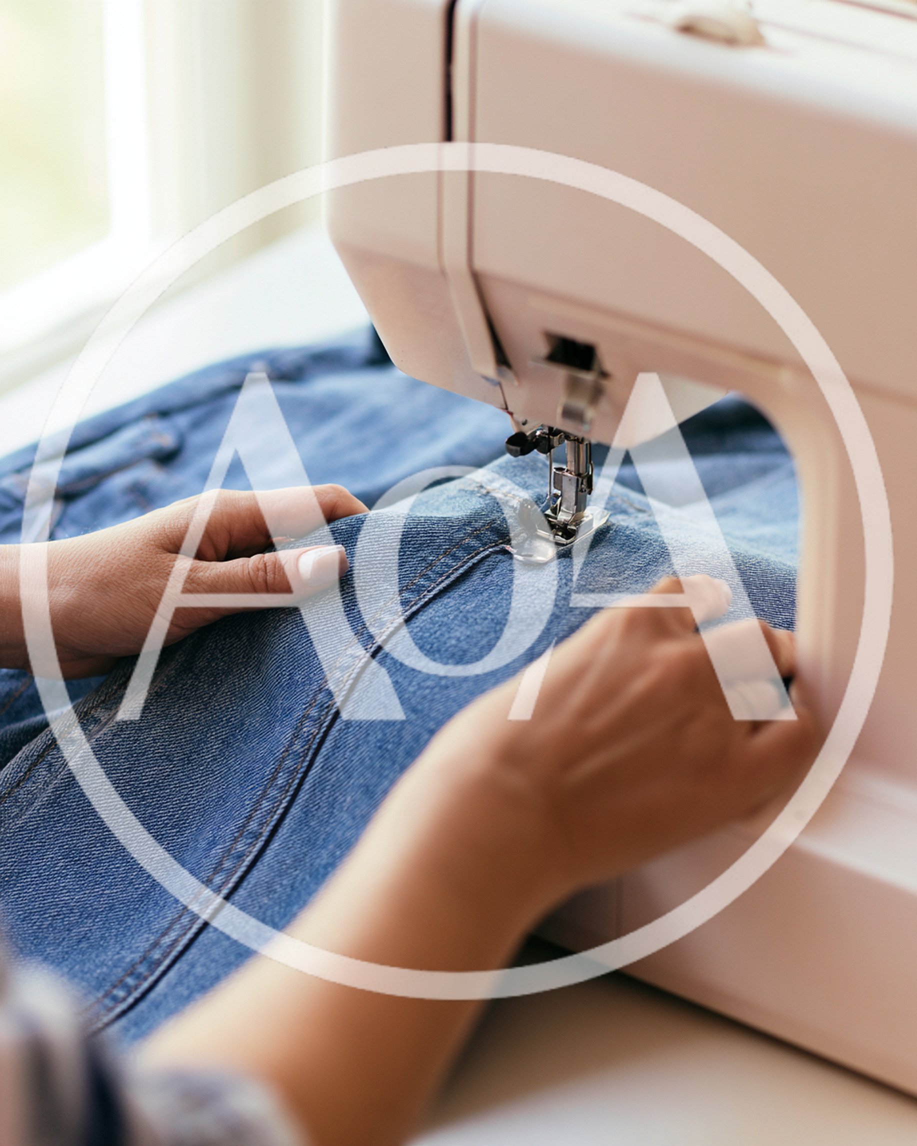 Close Up Of Hands Sewing Denim Fabric On Machine